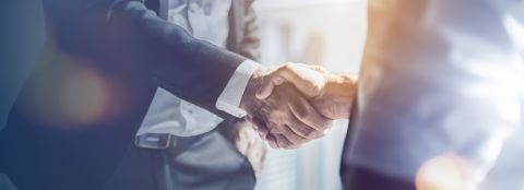 Two business people shake hands.
