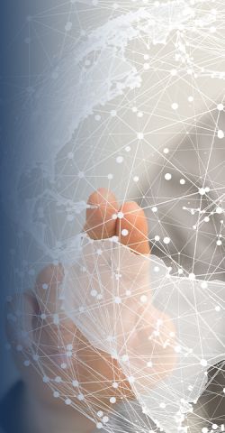 A man stretches out his arm and points with his index finger to a networked globe graphic in the foreground.